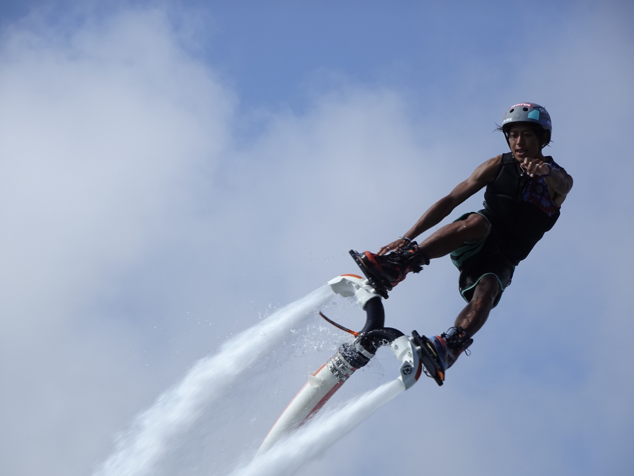 Man riding a flyboard high in the air, pointing towards the camera Click to open modal