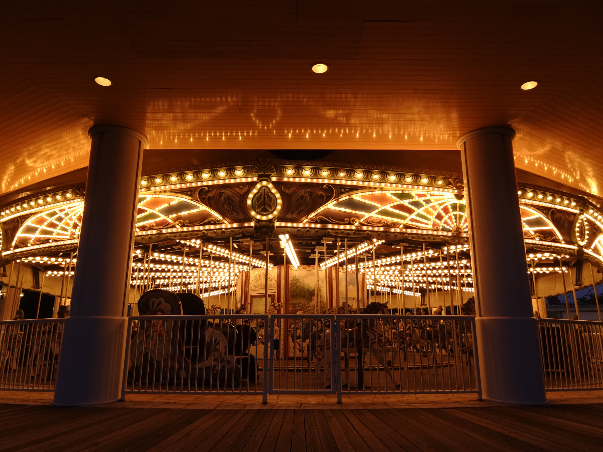 A carousel lit up at night Click to open modal