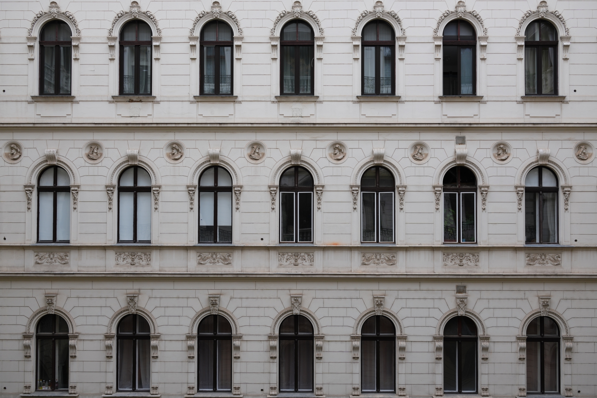 A sample image of a white building with evenly spaced windows. Click to open modal