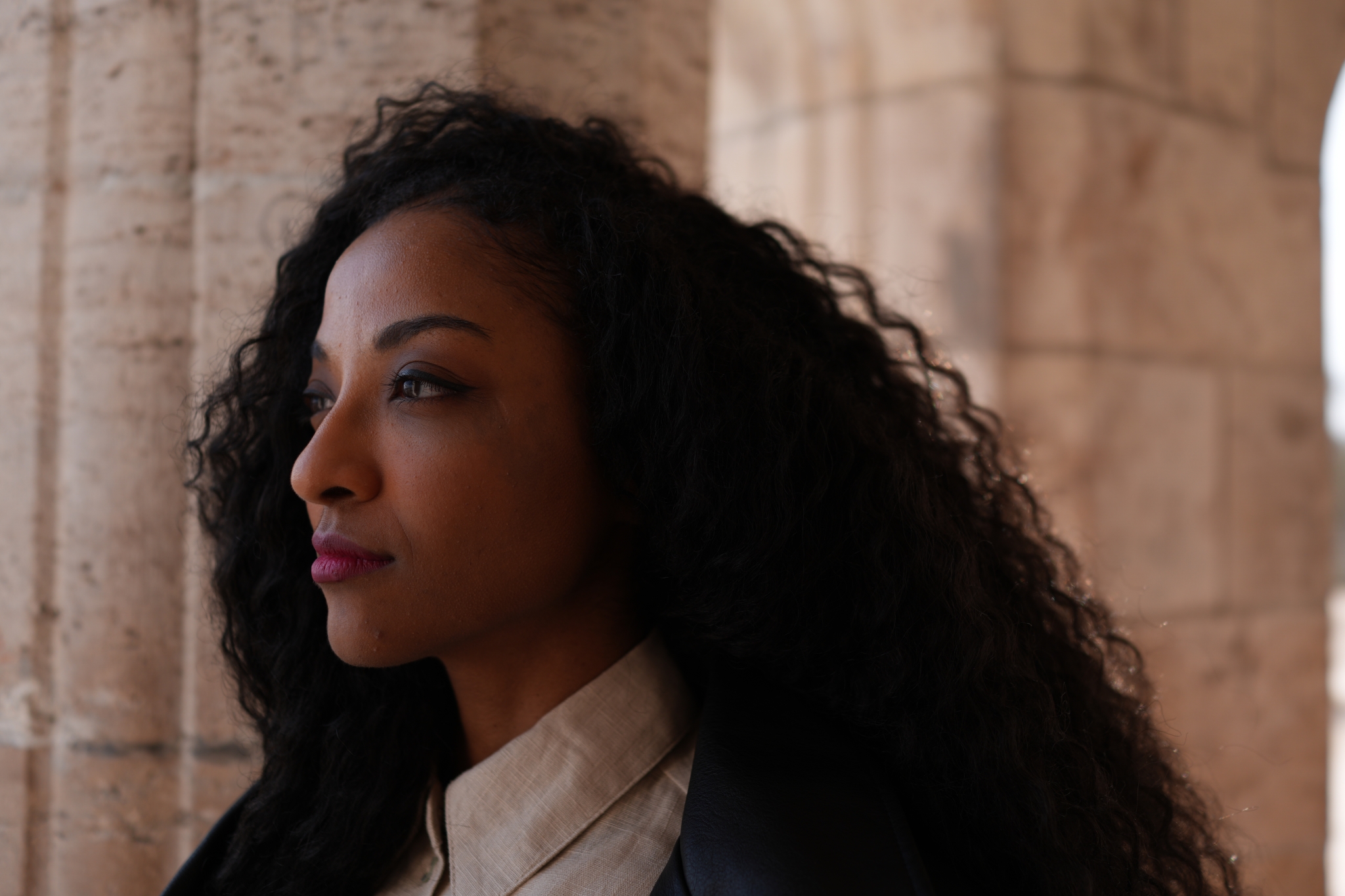 A woman looking on the side Click to open modal