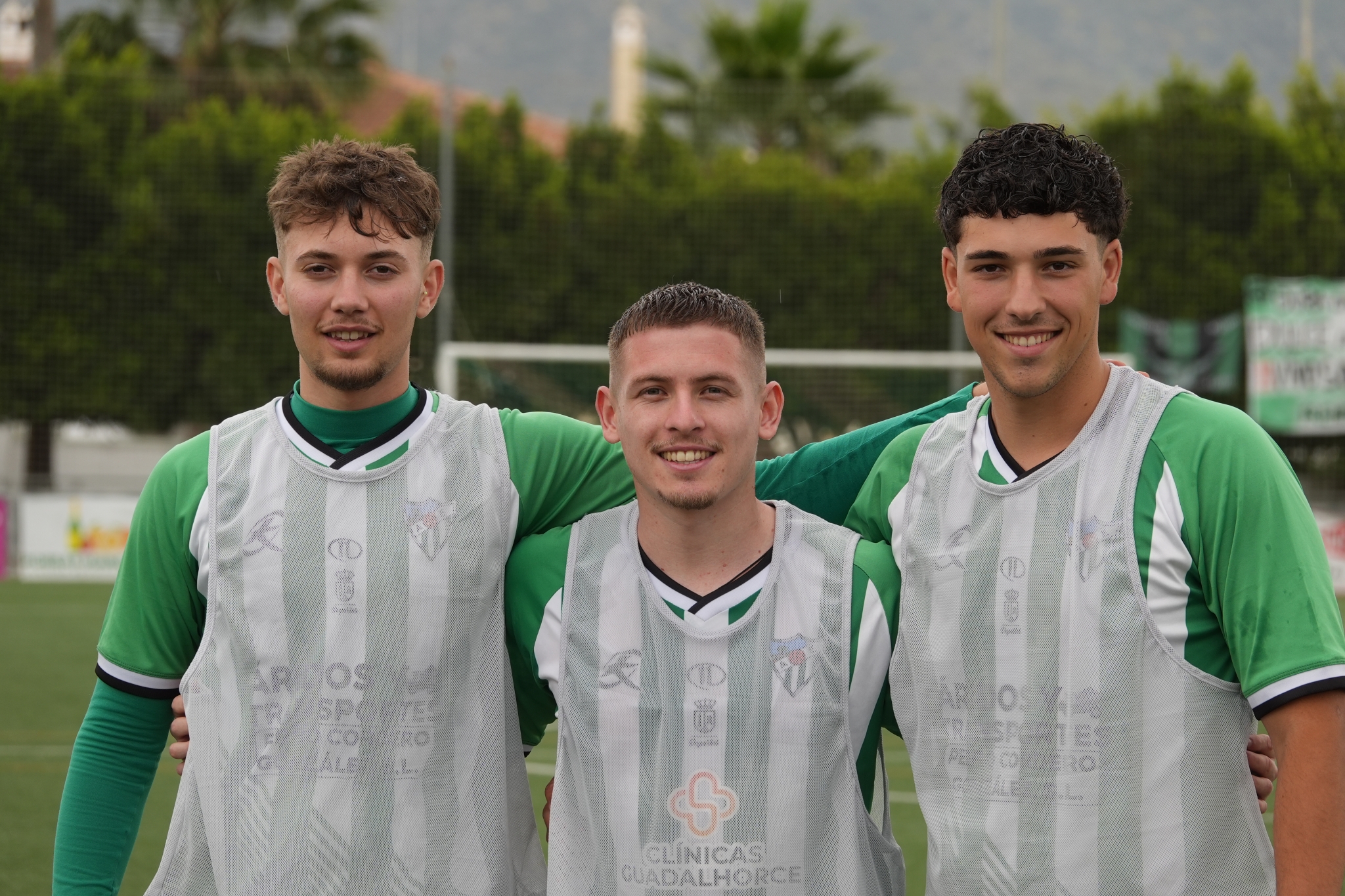 A sample image of the three male soccer players arm on each other shoulders Click to open modal