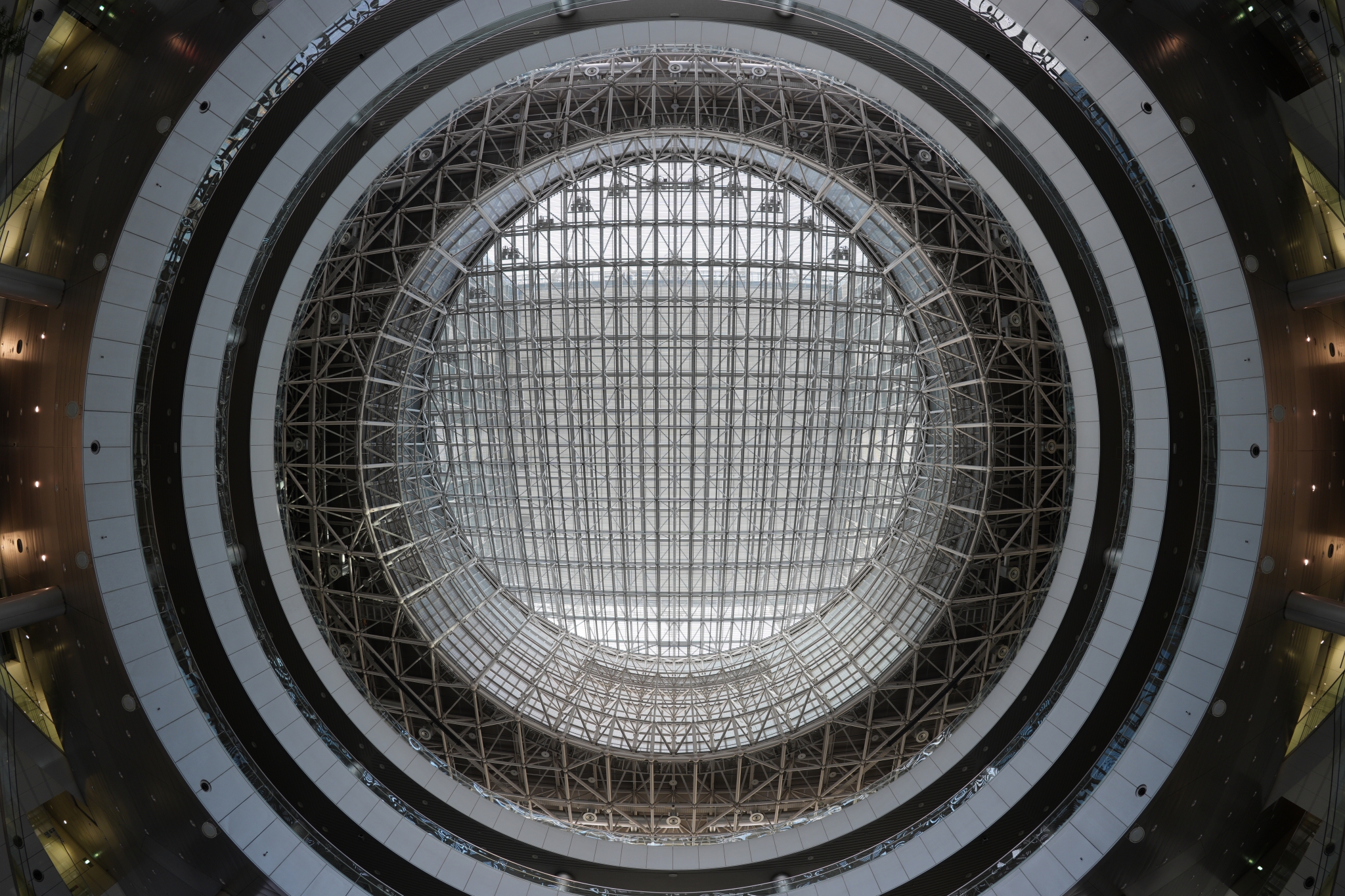 View of ornate domed ceiling with concentric circular rings and decorative metallic details, looking upward from below Click to open modal