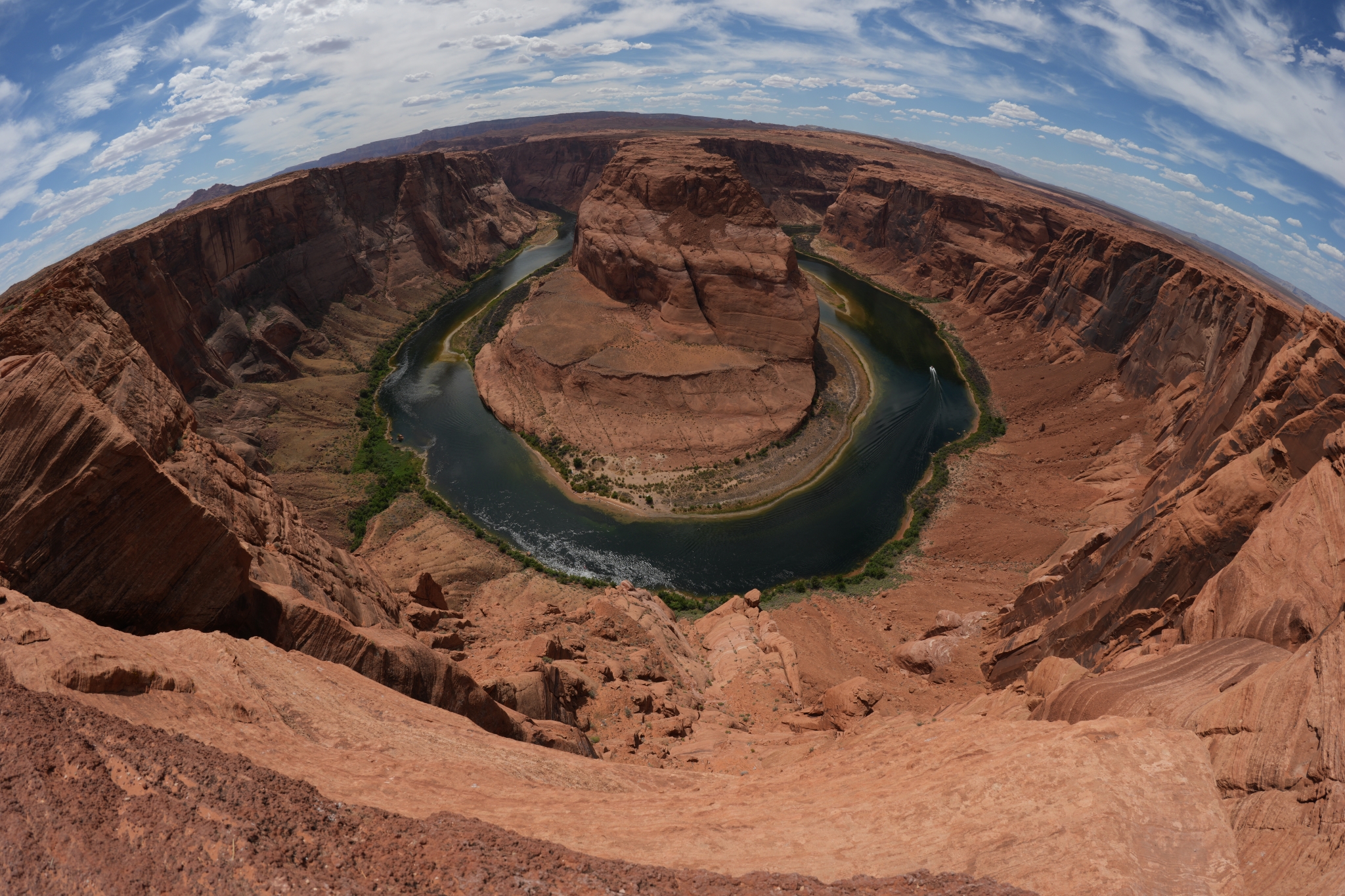 Aerial view of a horseshoe-shaped river bend cutting through red desert canyon walls Click to open modal