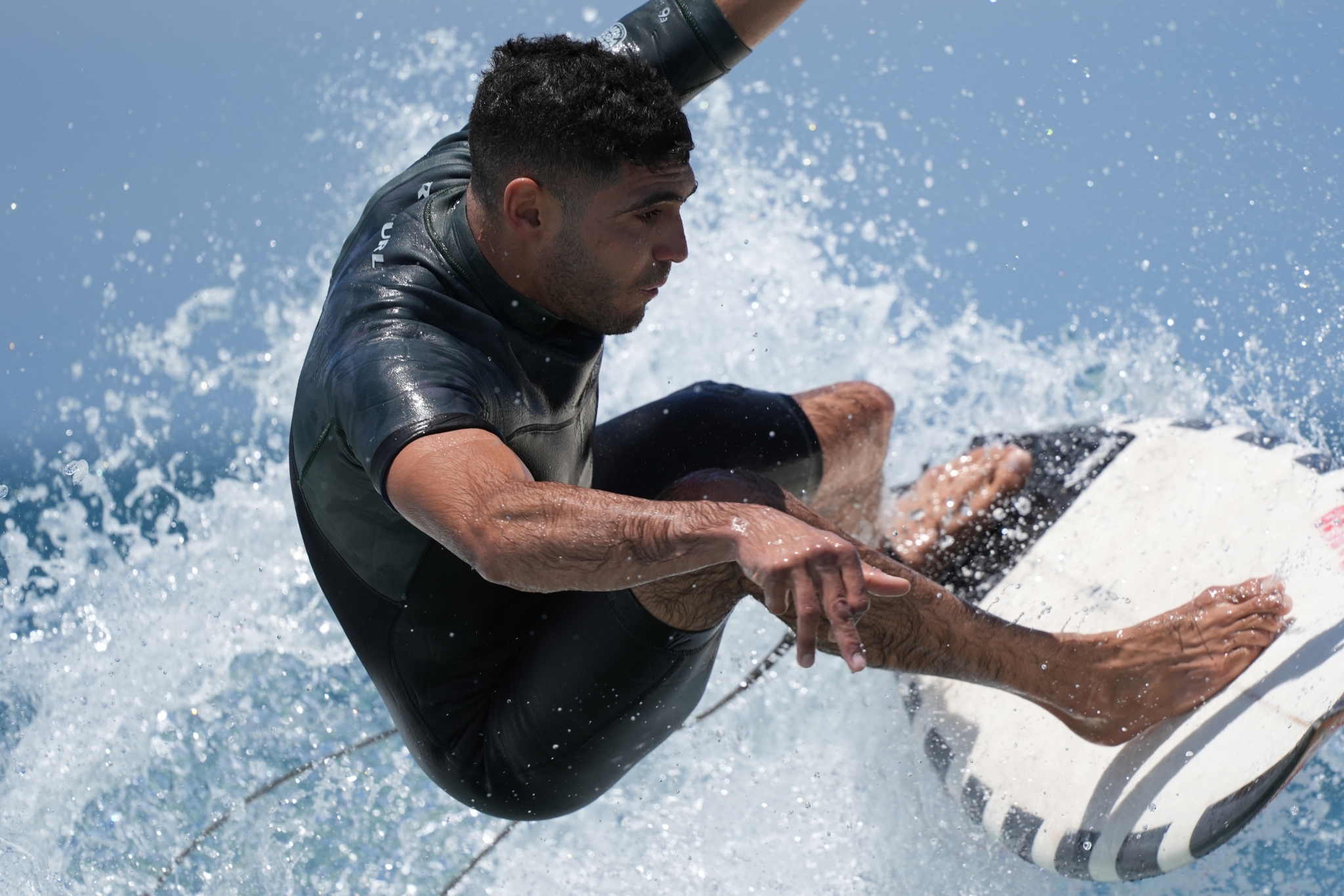 Male surfer carving through a breaking ocean wave Click to open modal