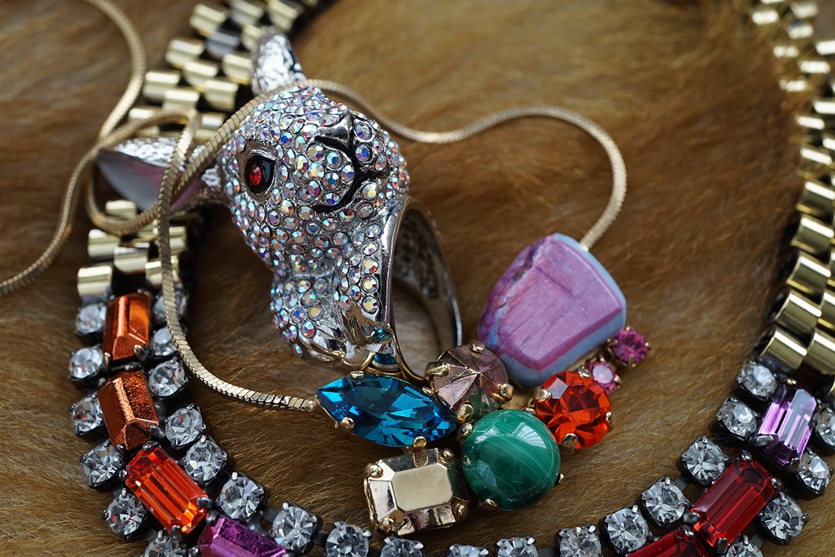 Close-up of necklace and other jewellery and trinkets Click to open modal