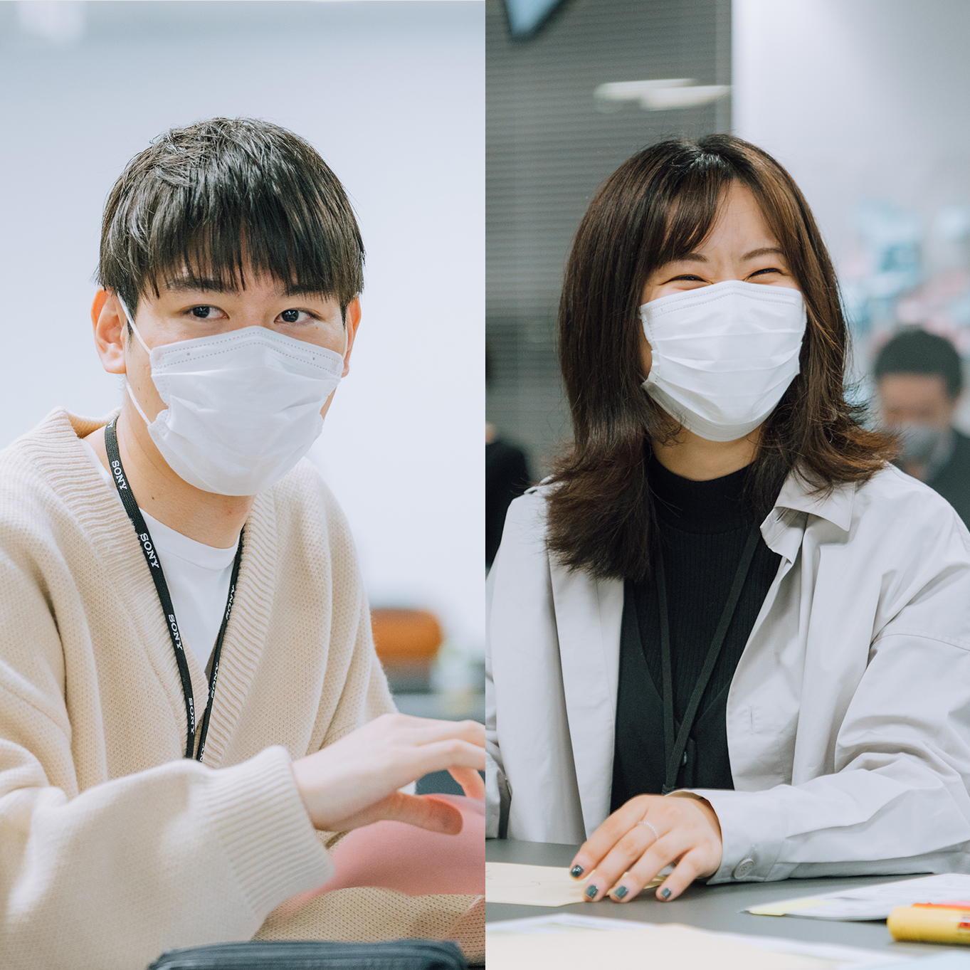 A man and a woman are chatting in the workshop. The man on the left and the woman on the right, both wearing masks.