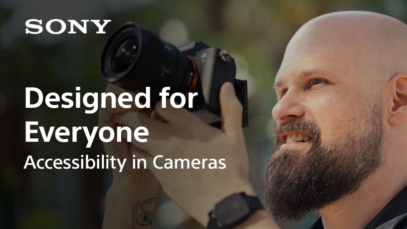 Sam Seavey holding a camera. Designed for Everyone: Accessibility in Cameras